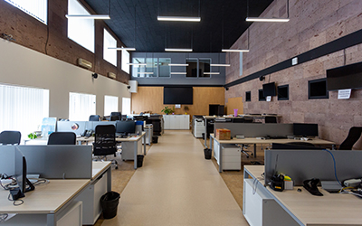 Commercial office interior with overhead lighting and workstations