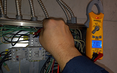 Electrical testing inside a panel using a clamp meter