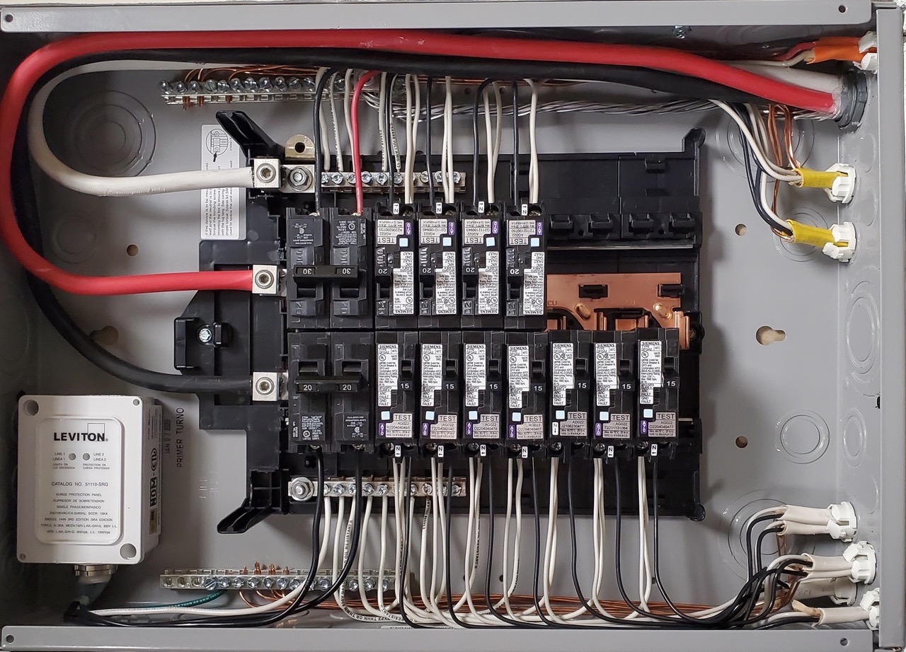 Open electrical panel showing circuit breakers and wiring