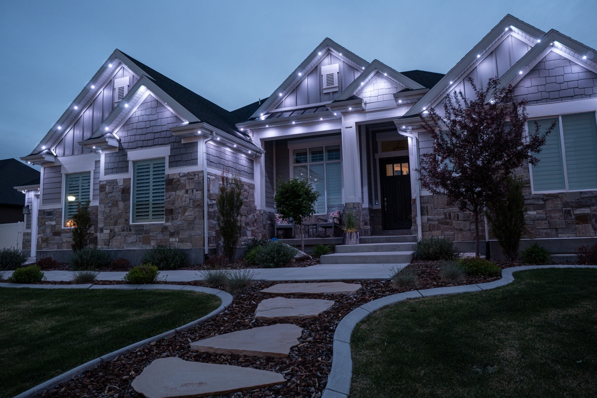 Home exterior with permanent roofline lighting